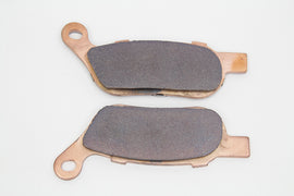 Duro Sintered Rear Brake Pad Set for motorcycle, showing metal brake pads with textured surface and mounting hardware.