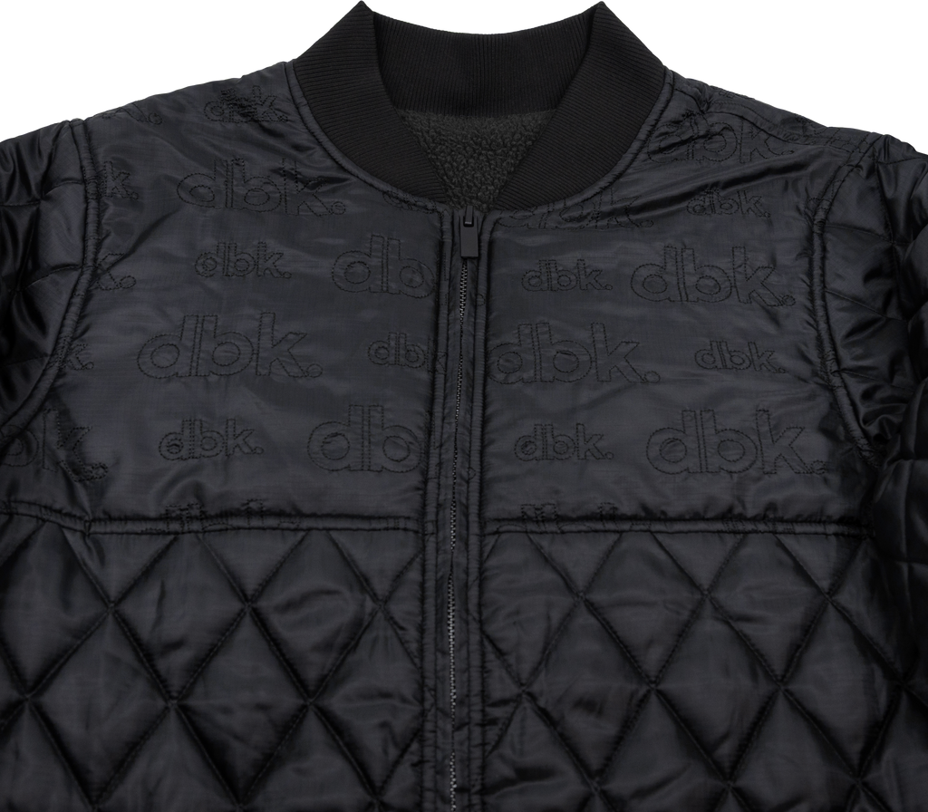Black DBK liner jacket shown on a hanger, featuring a sleek design and lightweight fabric for versatile wear.