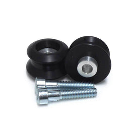 Black swingarm sliders by SHOGUN, sturdy body protection for motorcycle swingarms, shown mounted on a bike.