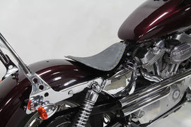 Bates Bobber Solo Seat for motorcycle with leather saddlebag, featuring a sleek, low-profile design and durable construction.