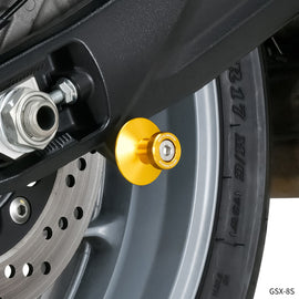 Gold ZETA swingarm spools M8 body mount for motorcycle, designed for easy wheel removal and stability.