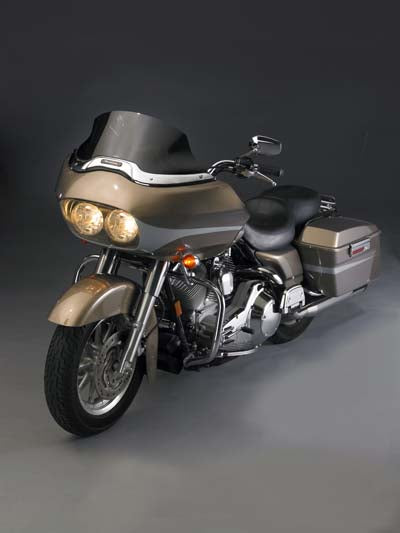 Dark tint V-Stream windshield for motorcycle with low profile design, fitting sissy bar and providing wind protection.