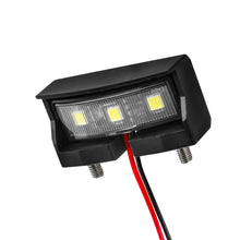 Load image into Gallery viewer, ZETA ZR45-3510 black compact license plate light for vehicle illumination, shown in close-up with clear lens and mounting area.