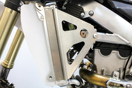 WORKS Radiator Braces guards installed on a vehicle, designed to protect the radiator from damage and debris.