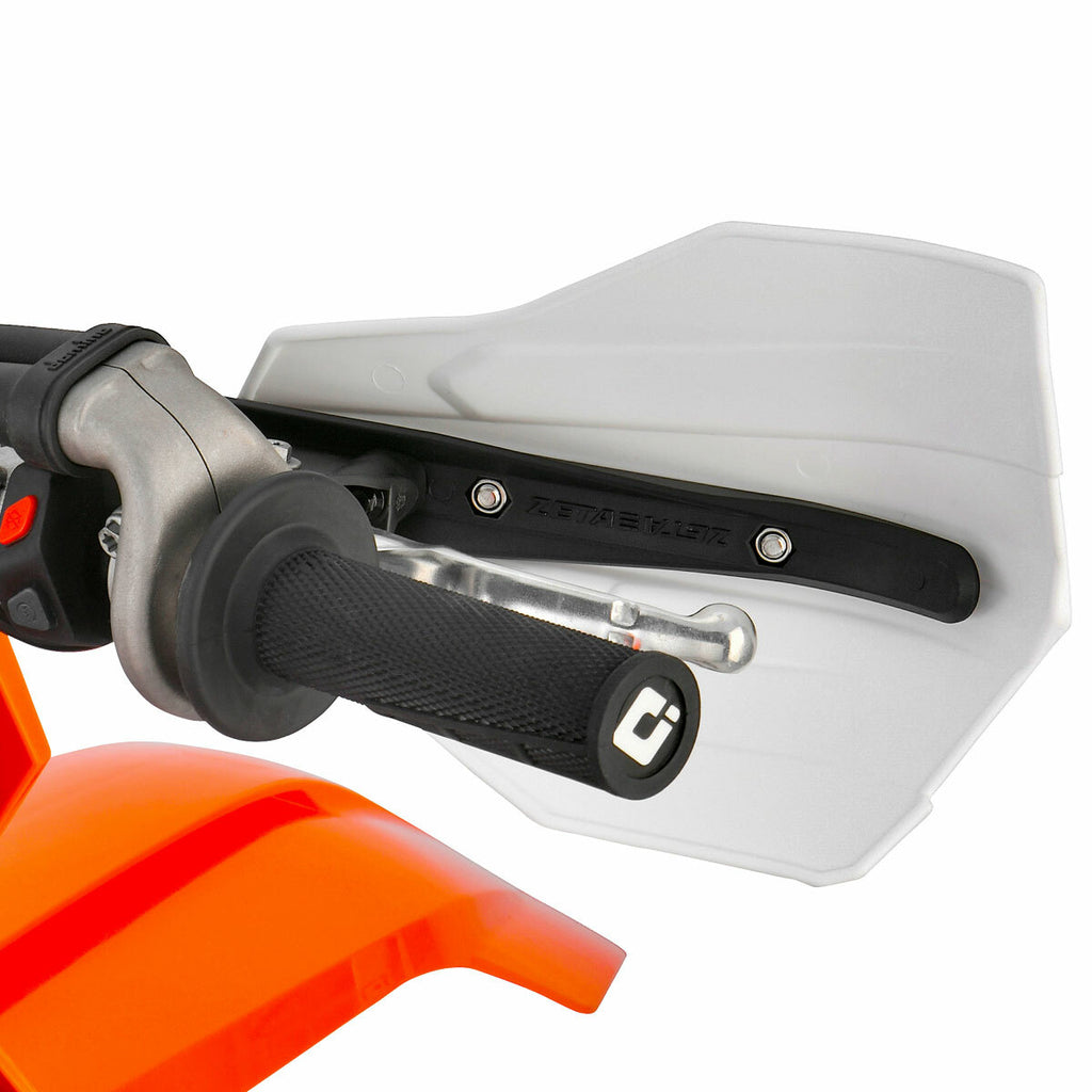 White ZETA Xc Pro Convert handguards mounted on a motorcycle handlebar, showcasing their sturdy design and protective features.
