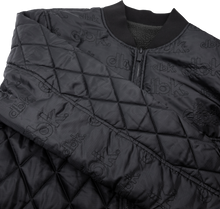 Load image into Gallery viewer, Black DBK liner jacket with a sleek design, shown on a hanger, highlighting the lightweight and versatile outerwear style.