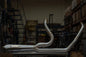 Stainless Cone Performance 2:1 breakaway performance exhaust for Harley Bagger 1995-2016, with polished finish and dual outlets.