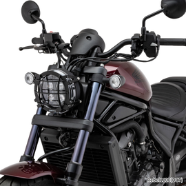 Black ZETA headlight guard for illumination, designed for motorcycle headlights, providing protection and a sleek look.
