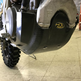 P3 Brand carbon fiber skid plate guard for motorcycle, showing sleek black carbon fiber surface and mounting edges.