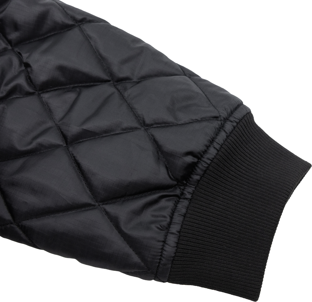 Black DBK liner jacket with a sleek, padded design, shown with front zipper and collar, perfect for layering and cold weather.