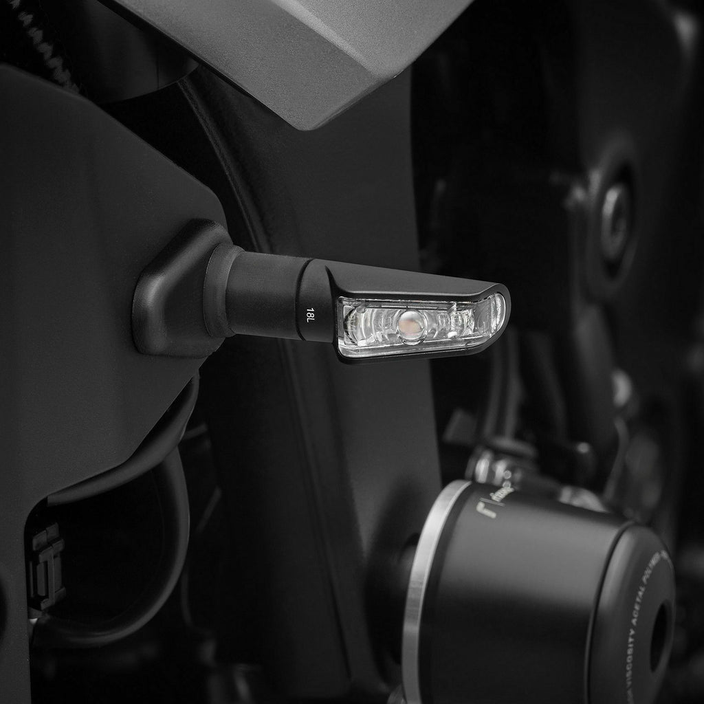 Pair of RIZOMA Leggera black turn signal lights for motorcycle illumination, featuring sleek design and durable construction.