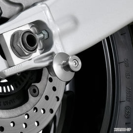 Titanium swingarm spools for motorcycle body, M6 size, by ZETA, mounted on a motorcycle swingarm for easy wheel removal.