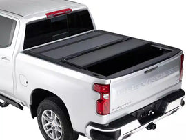 Maverick hardtop folding tonneau cover on a 2016 Toyota Tacoma truck for secure bed protection.