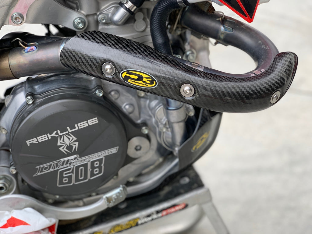 P3 brand heat shield made of carbon fiber for exhaust systems, showcasing its sleek black textured surface and lightweight design.