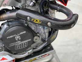 P3 brand heat shield made of carbon fiber for exhaust systems, showcasing its sleek black textured surface and lightweight design.