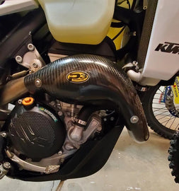 P3 brand heat shield for KTM and Husqvarna exhausts, made of carbon fiber with a sleek, protective design.
