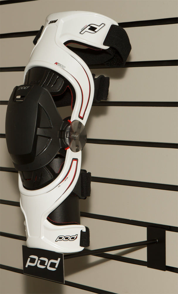 POD knee brace slatwall display showcasing multiple POD knee braces in a retail setting.