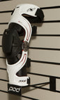 POD knee brace slatwall display showcasing multiple POD knee braces in a retail setting.