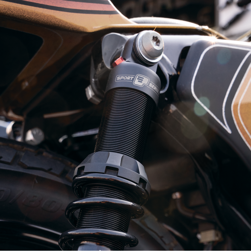 Progressive Suspension 494 Sport Series shocks installed on Harley Davidson Sportster motorcycle, showing the adjustable shock absorbers.