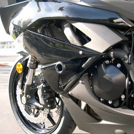 Black SHOGUN Body Frame Sliders for motorcycle protection, shown mounted on a bike in this image.