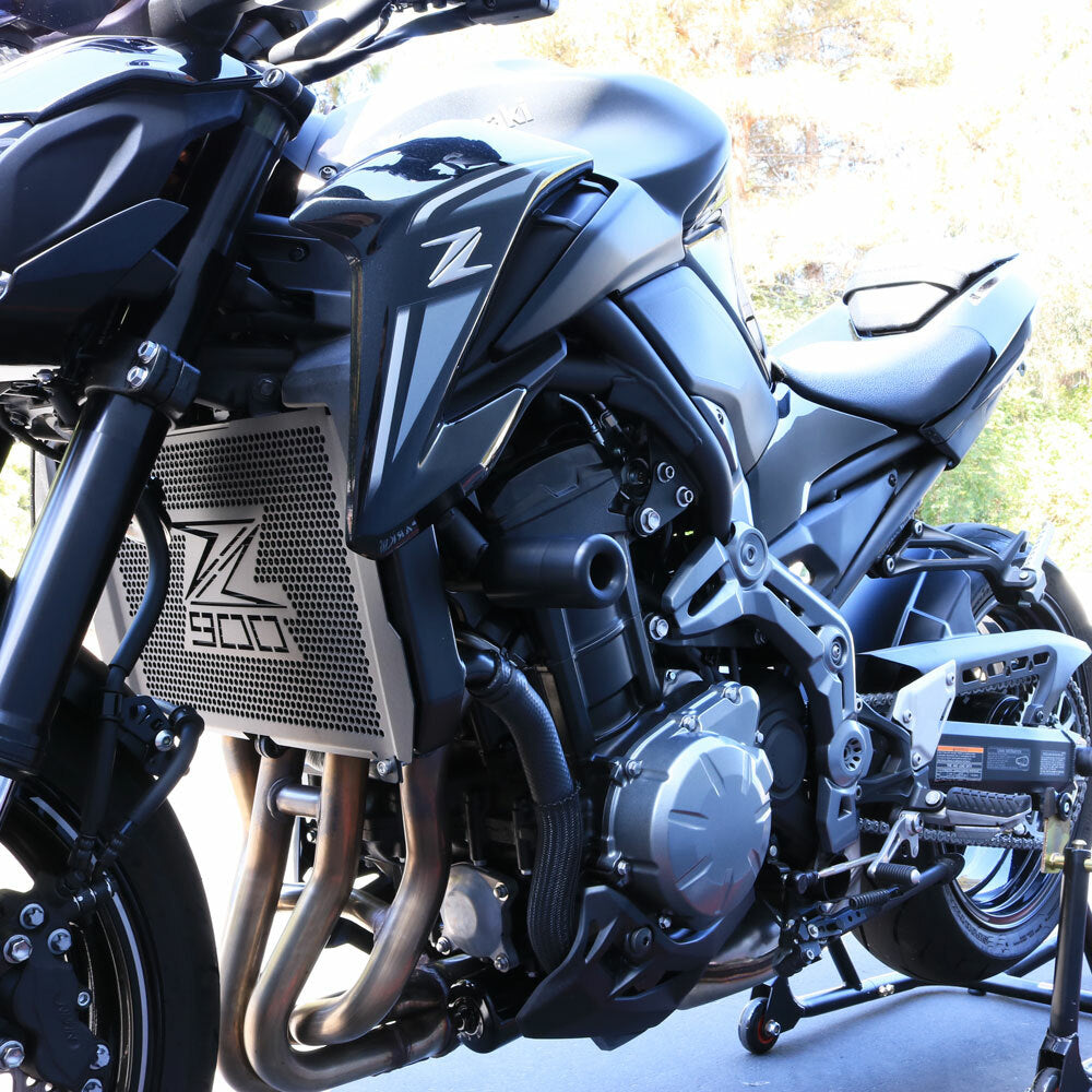 Black Shogun Frame Sliders for Kawasaki motorcycle, body protection accessory with durable construction.