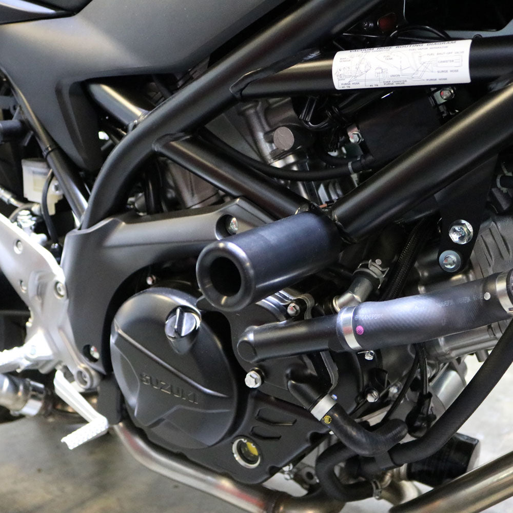 Black Suz Frame Sliders for motorcycle body protection by SHOGUN, shown on a sleek bike.