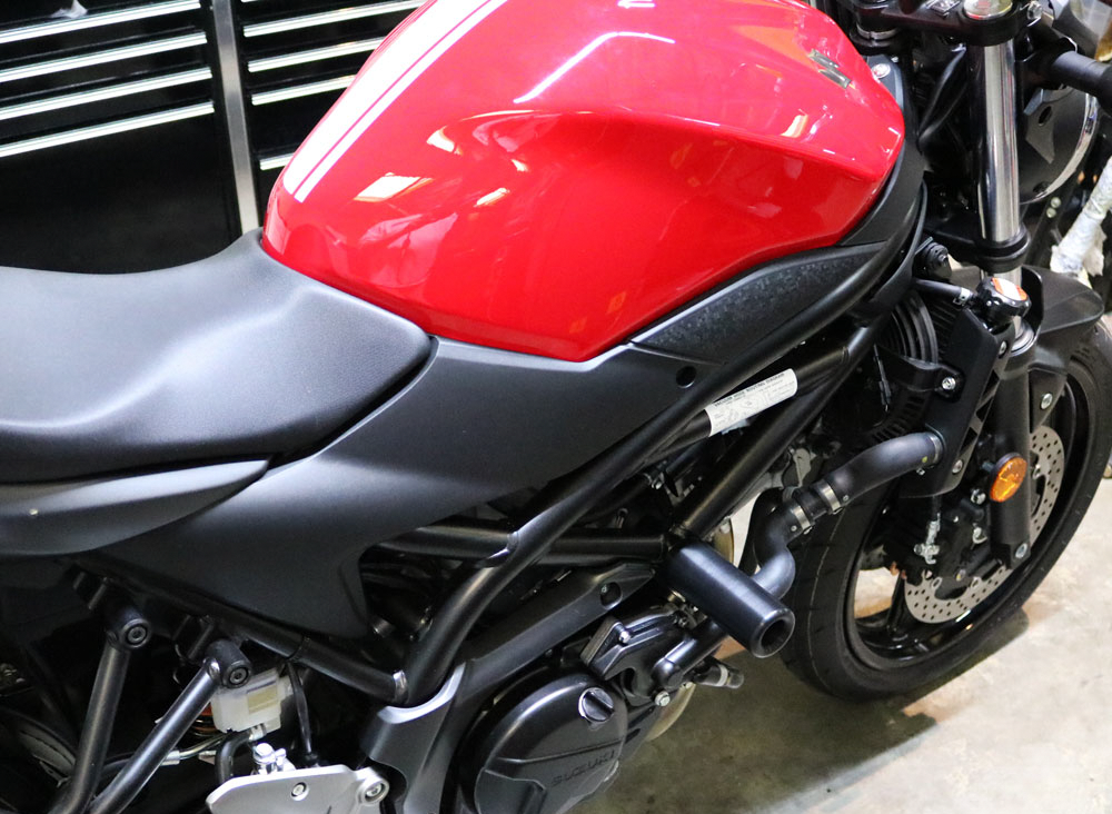 Black Suz body frame sliders for motorcycle by SHOGUN, designed for protection and stability during rides.