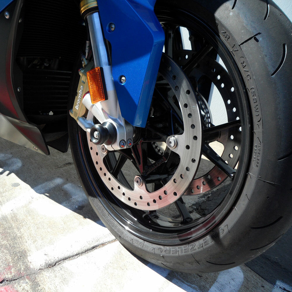 Black Shogun front axle sliders mounted on a motorcycle body for protection and style.