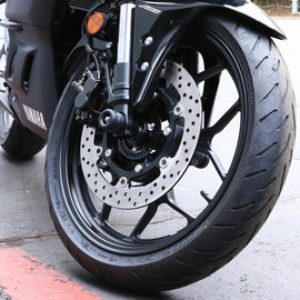 Black Shogun front axle sliders for motorcycle body protection, designed to absorb impacts and prevent damage during falls.