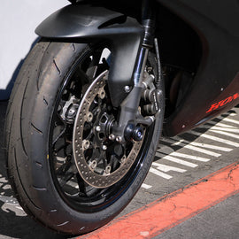 Black front axle sliders for motorcycle by SHOGUN, body protection components with durable construction.