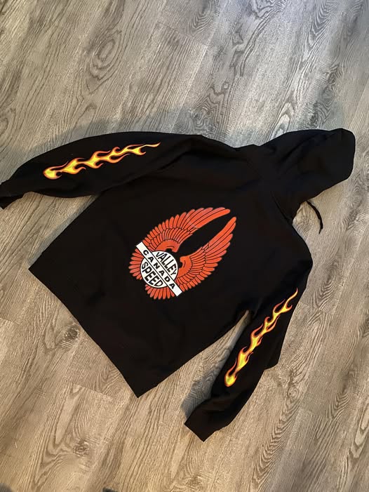 The Speed Shop Canada zip-up hoodie with colorful graphic design, front zipper, and casual fit, perfect for streetwear style.
