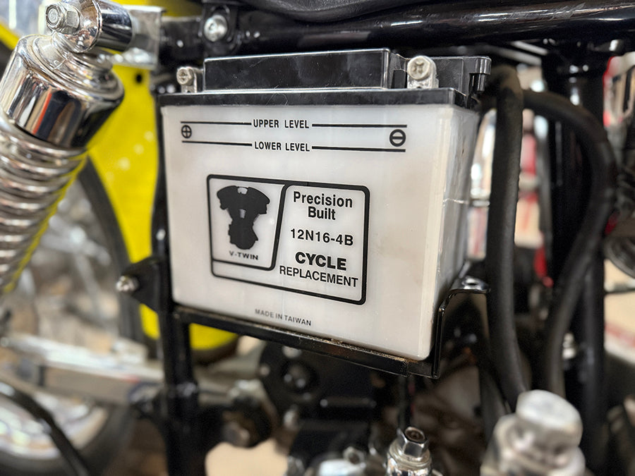 Black V-Twin Battery Carrier Kit for electrical systems, featuring mounting hardware and secure fit for motorcycle batteries.