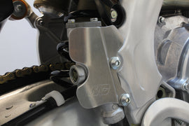 WORKS Rear Master Cylinder Guard for motorcycle, durable metal guard to protect the rear master cylinder and brake components.