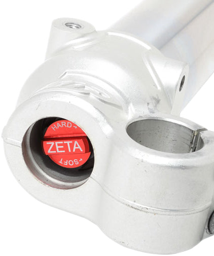 ZETA front fork bottom adjuster for suspension, showing the black metal component with adjustment screws and branding details.
