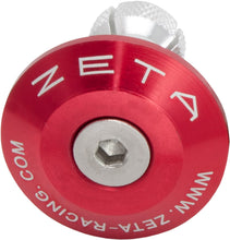 Load image into Gallery viewer, Red ZETA bar end plug attached to bicycle handlebar, showcasing durable bike accessory design.