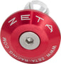 Red ZETA bar end plug attached to bicycle handlebar, showcasing durable bike accessory design.